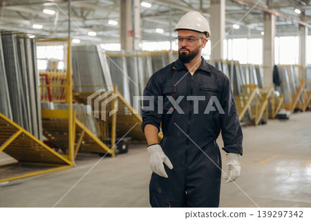 Bunch of raw windows parts. Warehouse worker in an industrial environment of a factory or storage area Bunch of raw windows parts. Warehouse worker in an industrial environment of a factory or storage area 139297342