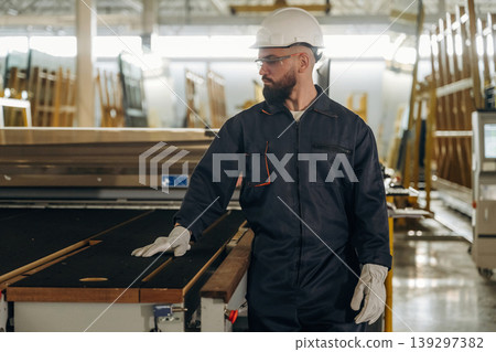 Confident look, quality control. Warehouse worker in an industrial environment of a factory or storage area 139297382