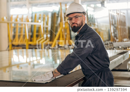 Crystal clear glass. Warehouse worker in an industrial environment of a factory or storage area Crystal clear glass. Warehouse worker in an industrial environment of a factory or storage area 139297394