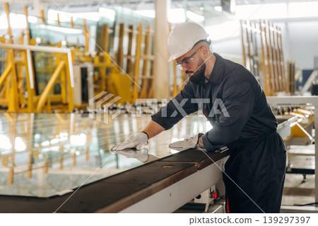 Crystal clear glass. Warehouse worker in an industrial environment of a factory or storage area Crystal clear glass. Warehouse worker in an industrial environment of a factory or storage area 139297397
