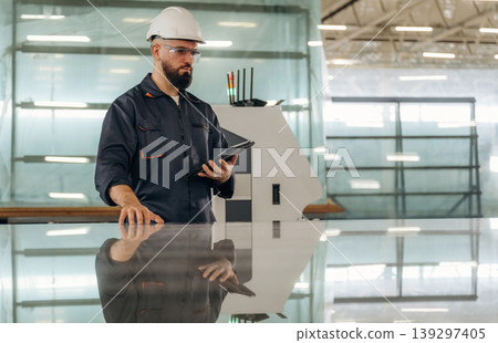 Finished clean glass, checking the product. Warehouse worker in an industrial environment of a factory or storage area Finished clean glass, checking the product. Warehouse worker in an industrial environment of a factory or storage area 139297405
