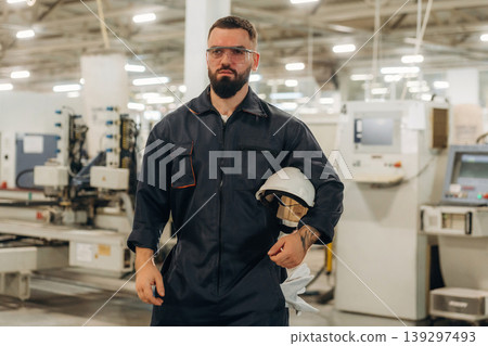 Production conception, quality control. Warehouse worker in an industrial environment of a factory or storage area Production conception, quality control. Warehouse worker in an industrial environment of a factory or storage area 139297493