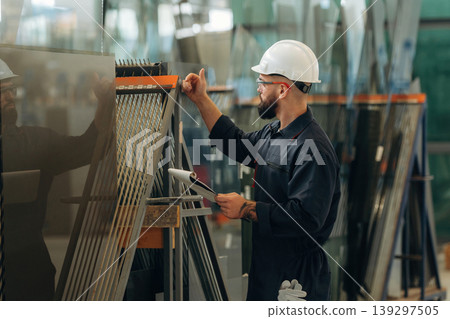Warehouse worker in an industrial environment of a factory or storage area Warehouse worker in an industrial environment of a factory or storage area 139297505