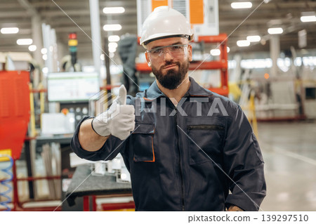 Everything is under control, showing hand gesture. Warehouse worker in an industrial environment of a factory or storage area Everything is under control, showing hand gesture. Warehouse worker in an industrial environment of a factory or storage area 139297510