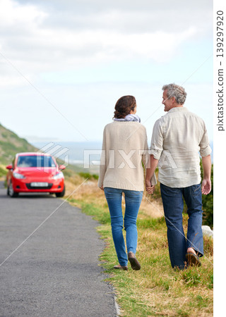 Old couple, walking and holding hands in nature on holiday, vacation or retirement with support. Back, man and woman with love, car and happiness in marriage together on a road trip or journey 139297920