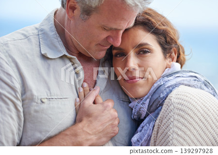 Couple, face and smile outdoor with hug for romance, love and relationship in nature with date. Mature, man and woman or embrace with happy, marriage and joy for bonding, honeymoon and support 139297928