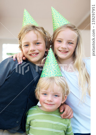 Family, children and portrait at birthday party, smile and celebration together in home. Happy kids, siblings and hat for event, face and bonding, care or support of brother, sister and girl in house Family, children and portrait at birthday party, smile and celebration together in home. Happy kids, siblings and hat for event, face and bonding, care or support of brother, sister and girl in house 139297951