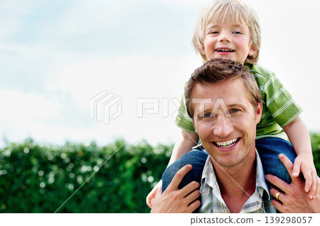 Father, son and portrait or smile with piggyback for bonding, relationship and freedom with blue sky in garden. Family, man and boy child with playing, care and love for excitement, peace and support 139298057