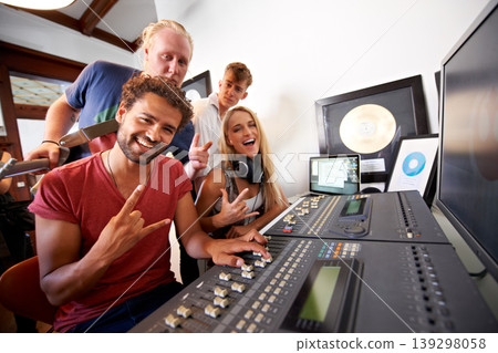 Recording studio, rock sign and portrait of people for music, radio and audio with musical instruments. Hand emoji, soundboard and happy men and women with sound engineer or producer to record media Recording studio, rock sign and portrait of people for music, radio and audio with musical instruments. Hand emoji, soundboard and happy men and women with sound engineer or producer to record media 139298058