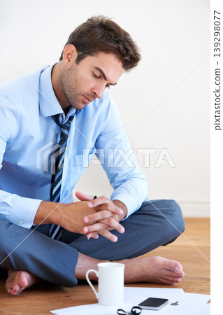 Stress, finance and bankruptcy with a business man reading tax paper or a budget on the floor of his apartment. Accounting, documents and anxiety with a young employee looking worried about debt Stress, finance and bankruptcy with a business man reading tax paper or a budget on the floor of his apartment. Accounting, documents and anxiety with a young employee looking worried about debt 139298077