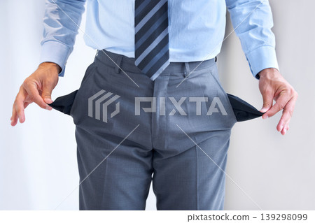 Hands, bankrupt and broke with pockets of a business person in studio on a white background. Economy, debt or financial crisis and a poor or jobless employee with poverty problems during a recession Hands, bankrupt and broke with pockets of a business person in studio on a white background. Economy, debt or financial crisis and a poor or jobless employee with poverty problems during a recession 139298099
