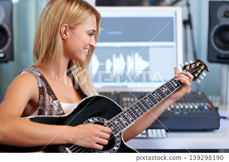 Woman, guitar and computer in recording studio for music with smile, ideas and creativity for art, album or song. Musician, artist and instrument with pc for sound, audio and happy for entertainment Woman, guitar and computer in recording studio for music with smile, ideas and creativity for art, album or song. Musician, artist and instrument with pc for sound, audio and happy for entertainment 139298190