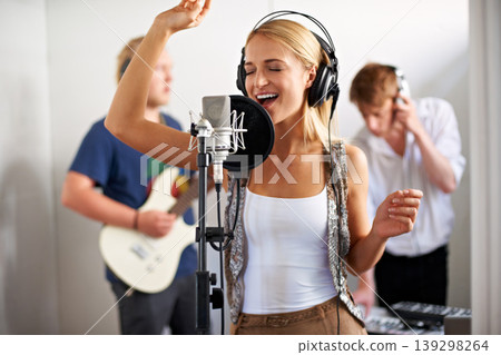Professional, musician and happy woman with microphone, headphones and band performance with talent. Recording studio, art and girl singer live streaming for music label, sound and audio broadcast. 139298264