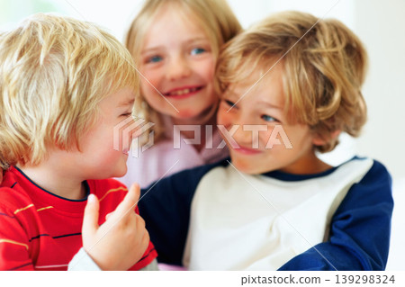 Family, kids and funny face in the bedroom with brother siblings playing together in their home. Love, smile or having fun with boy and girl children on a bed in their apartment for weekend bonding 139298324