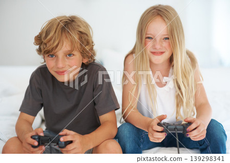 Smile, children playing video game on sofa or portrait together in home living room for competition. Happy kids, brother and sister on controller technology, family entertainment and bond in house Smile, children playing video game on sofa or portrait together in home living room for competition. Happy kids, brother and sister on controller technology, family entertainment and bond in house 139298341