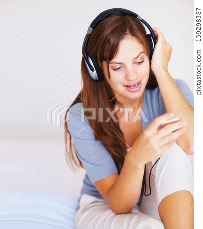 Headphone music player, bed or woman listening to playlist track, audio podcast or wellness sound. Relax morning, home bedroom or user streaming stress relief song, media network or digital radio app Headphone music player, bed or woman listening to playlist track, audio podcast or wellness sound. Relax morning, home bedroom or user streaming stress relief song, media network or digital radio app 139298387
