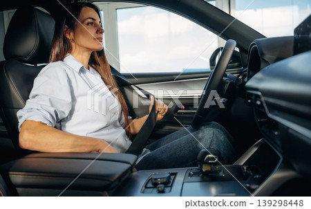Wearing the safety belt. Woman is sitting in the modern car, happy new owner 139298448