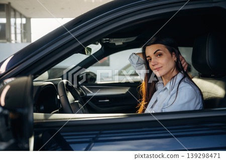 Woman is sitting in the modern car, happy new owner Woman is sitting in the modern car, happy new owner 139298471