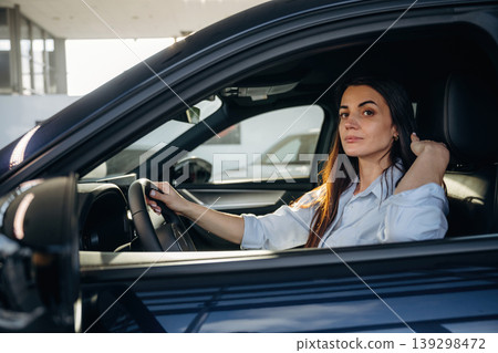 Woman is sitting in the modern car, happy new owner Woman is sitting in the modern car, happy new owner 139298472