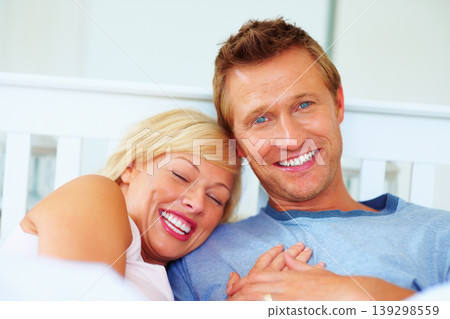 Couple, portrait and smile in bed of home for love, care and relax for holiday, break and support together. Man bond with woman in bedroom for happy relationship, freedom and romance in the morning 139298559