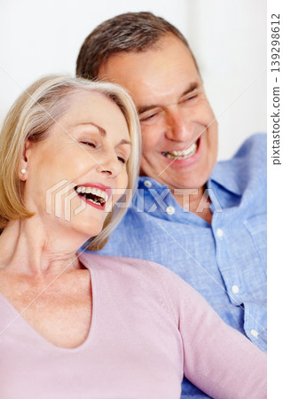 Senior, couple and face or laughing on sofa with support, relationship and marriage in retirement home. Elderly, man and woman with happy on couch in living room with relax, care and love in house 139298612