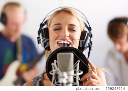 Happy woman, singer and microphone with headphones in music recording studio, sound track or podcast. Female person, blonde or musician smile on mic for audio listening, content creation and karaoke 139298614