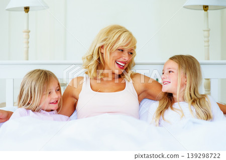 Happy, smile and mother with children on bed for bonding, talking and relaxing together at home. Excited, love and young mom chilling and resting with girl kids from Australia in bedroom of house. Happy, smile and mother with children on bed for bonding, talking and relaxing together at home. Excited, love and young mom chilling and resting with girl kids from Australia in bedroom of house. 139298722