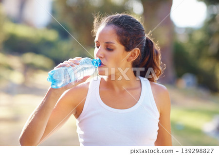 Young woman, drinking water and workout in nature for exercise, running break and health, energy or fitness. Tired and thirsty runner or sports person with bottle for training outdoor, park or forest Young woman, drinking water and workout in nature for exercise, running break and health, energy or fitness. Tired and thirsty runner or sports person with bottle for training outdoor, park or forest 139298827