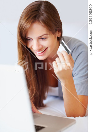 Home, woman and credit card with a laptop, online shopping and connection with a smile, buying and payment. Person, bedroom or girl with a computer, ecommerce and transaction with subscription or app 139298860