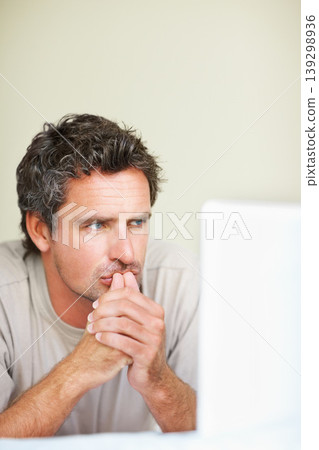 Thinking, man in house and laptop for work from home, serious and sitting alone for freelance job idea. Technology, entrepreneur and remote worker for online job, company and marketing projects Thinking, man in house and laptop for work from home, serious and sitting alone for freelance job idea. Technology, entrepreneur and remote worker for online job, company and marketing projects 139298936