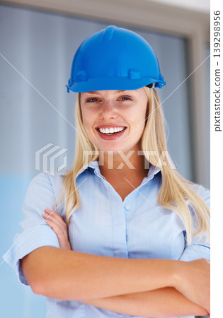 Architecture, portrait of happy woman with confidence and helmet for safety on construction site. Civil engineering, project management and property development, female contractor with arms crossed. Architecture, portrait of happy woman with confidence and helmet for safety on construction site. Civil engineering, project management and property development, female contractor with arms crossed. 139298956