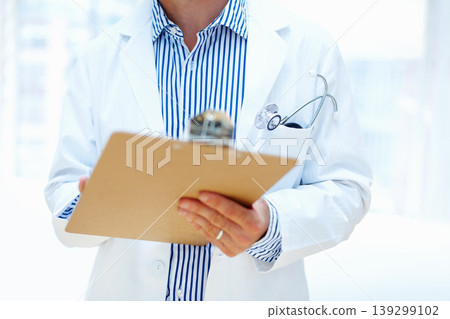 Hands, clipboard and man doctor a hospital for planning, schedule or surgery checklist closeup. Healthcare, compliance and male surgeon zoom with admin for insurance, documents or results analysis Hands, clipboard and man doctor a hospital for planning, schedule or surgery checklist closeup. Healthcare, compliance and male surgeon zoom with admin for insurance, documents or results analysis 139299102