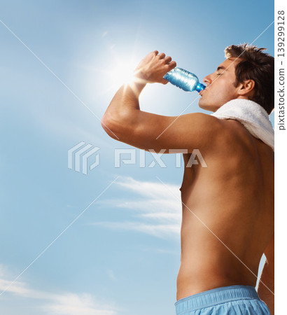 Man, drinking water and bottle with towel for workout, health body and fitness and vacation. Model, thirsty and natural glow with h2o drink for hydration and post cardio exercise by sky background Man, drinking water and bottle with towel for workout, health body and fitness and vacation. Model, thirsty and natural glow with h2o drink for hydration and post cardio exercise by sky background 139299128