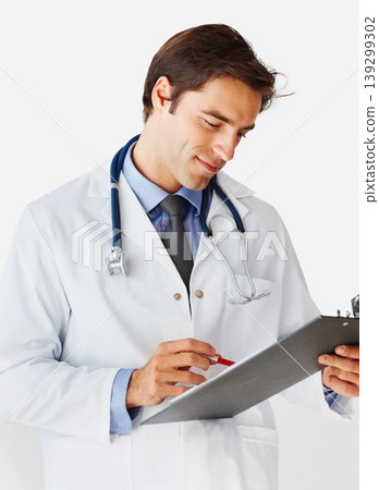 Man, doctor and writing on clipboard for prescription, appointment or checklist against a white studio background. Male person, surgeon or medical professional smile with notes or life insurance 139299302