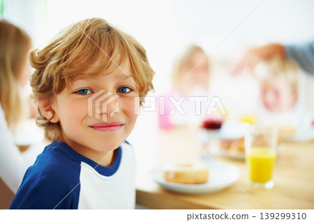 Kid, breakfast and portrait at home in the morning with food, smile and happy from eating. Family, dinner table and hungry young child with meal for health and nutrition in a house with juice Kid, breakfast and portrait at home in the morning with food, smile and happy from eating. Family, dinner table and hungry young child with meal for health and nutrition in a house with juice 139299310