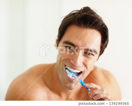 Bathroom, brushing teeth and man with oral health, wellness and grooming routine for fresh breath. Person, home or guy with toothbrush, cleaning his mouth and morning with dental hygiene or self care 139299368