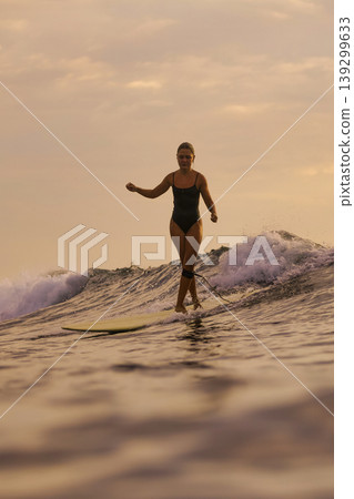 Active Lifestyle Depicted Through Focused Surfing Balance Exercise In Daylight Active Lifestyle Depicted Through Focused Surfing Balance Exercise In Daylight 139299633