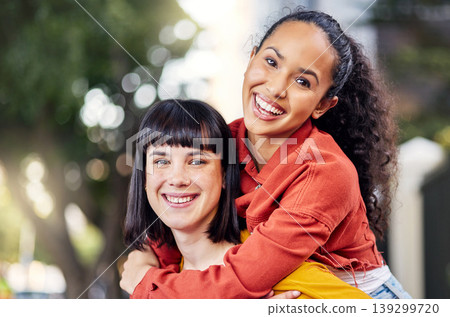 Couple of friends, lesbian and piggyback portrait outdoor for fun, travel and happiness or love on vacation. Young people in city for holiday or playful trip with a smile and joy to hangout in summer Couple of friends, lesbian and piggyback portrait outdoor for fun, travel and happiness or love on vacation. Young people in city for holiday or playful trip with a smile and joy to hangout in summer 139299720