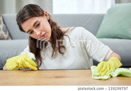 Woman, cloth and gloves for cleaning wood table for spray, chemical or hygiene in home living room. Girl, cleaner and services with liquid, fabric or product for dust, shine or stop bacteria in house Woman, cloth and gloves for cleaning wood table for spray, chemical or hygiene in home living room. Girl, cleaner and services with liquid, fabric or product for dust, shine or stop bacteria in house 139299797