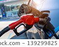 Petrol pump filling fuel nozzle in fuel tank of car at gas station. 139299825