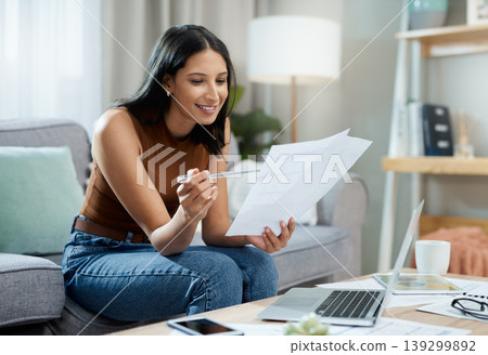 Happy woman, laptop and documents on sofa for finance, expenses or paying bills in living room at home. Female person smile with paperwork for good budget, investments or financial plan at house Happy woman, laptop and documents on sofa for finance, expenses or paying bills in living room at home. Female person smile with paperwork for good budget, investments or financial plan at house 139299892