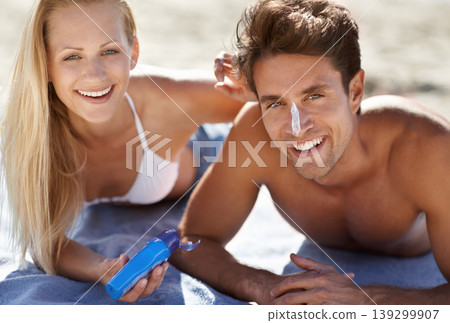 Love, portrait and sunscreen with happy couple on beach blanket for date, bonding and tropical holiday. Romance, man and woman with cream, skincare and relax together with travel and adventure. Love, portrait and sunscreen with happy couple on beach blanket for date, bonding and tropical holiday. Romance, man and woman with cream, skincare and relax together with travel and adventure. 139299907