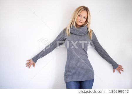 Woman, portrait and smile in studio with fashion, winter outfit or casual style with hands or wall. Person, face and happy on mock up space with confidence, pride and joyful on white background 139299942