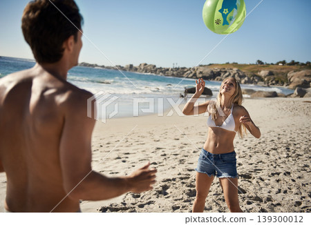 Couple, ball playing and fun by beach in summer with love, care and support together on a holiday. Happy, vacation and date by the sea in Miami with freedom and travel by the ocean on a trip outdoor 139300012