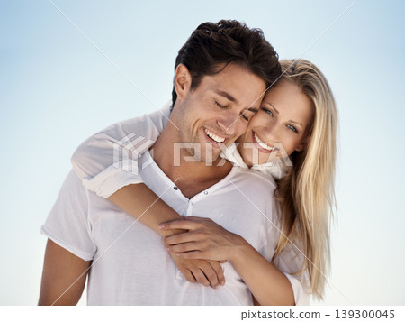 Love, embrace and happy couple in nature with blue sky for date, outdoor bonding and tropical holiday. Romance, man and woman, hugging and relax on vacation together with travel, care and adventure. Love, embrace and happy couple in nature with blue sky for date, outdoor bonding and tropical holiday. Romance, man and woman, hugging and relax on vacation together with travel, care and adventure. 139300045
