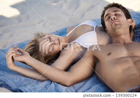 Love, holding hands and couple lying on beach for date, outdoor bonding or tropical holiday. Romance, man and woman at sea, trust and relax on ocean vacation together with travel, care and adventure Love, holding hands and couple lying on beach for date, outdoor bonding or tropical holiday. Romance, man and woman at sea, trust and relax on ocean vacation together with travel, care and adventure 139300124