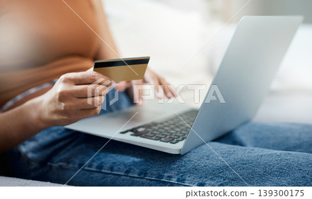 Laptop, credit card and hands for home online shopping, e commerce and digital payment or order on sofa. Relax person typing on computer for internet banking, subscription or registration for a loan Laptop, credit card and hands for home online shopping, e commerce and digital payment or order on sofa. Relax person typing on computer for internet banking, subscription or registration for a loan 139300175