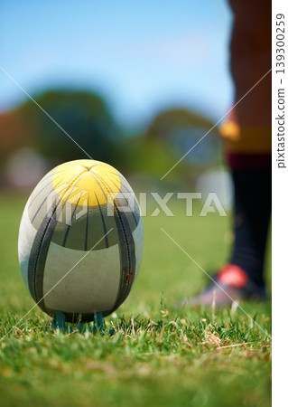 Closeup, rugby and leg with a ball of a player to kick for fitness training on a grass field. Man, uniform and sports exercise for healthy green lawn and active athlete playing for health Closeup, rugby and leg with a ball of a player to kick for fitness training on a grass field. Man, uniform and sports exercise for healthy green lawn and active athlete playing for health 139300259