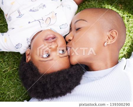 Mother, kiss and child on grass with black family, love and support together with baby in garden. Lawn, above and mom with happy kid, park smile and backyard with African mama and relax in nature Mother, kiss and child on grass with black family, love and support together with baby in garden. Lawn, above and mom with happy kid, park smile and backyard with African mama and relax in nature 139300290