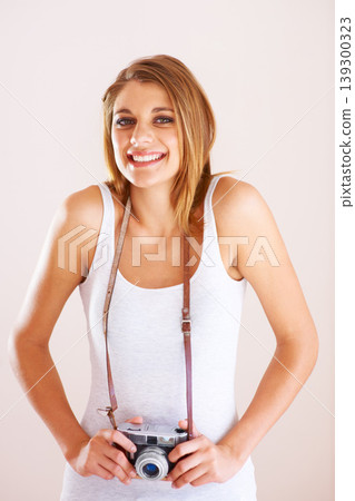 Smile, portrait and woman with camera in studio for photography, memory or nature on white background. Face, happy and female photographer with equipment for creative hobby, career or shooting Smile, portrait and woman with camera in studio for photography, memory or nature on white background. Face, happy and female photographer with equipment for creative hobby, career or shooting 139300323